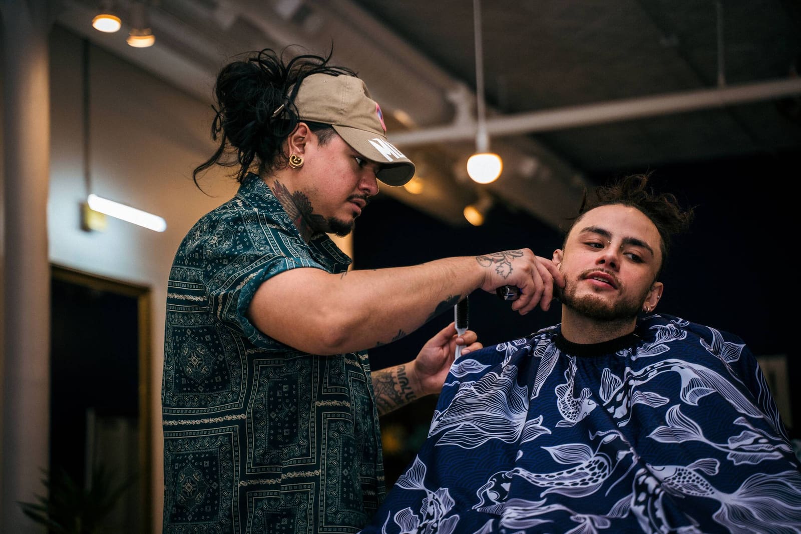 Dunny Valencia trimming a client's beard